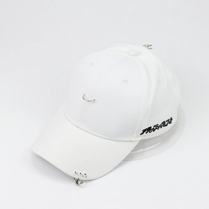 Détail d'une casquette blanche en coton avec trois anneaux métalliques sur la visière