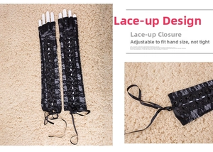 Detailed view of adjustable lace-up straps on long black gothic fingerless lace gloves