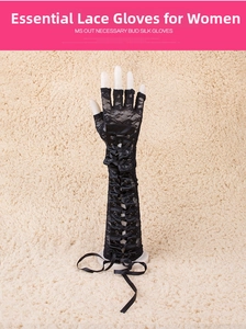Close-up of black lace fingerless gloves with elegant criss-cross ribbon lacing detail