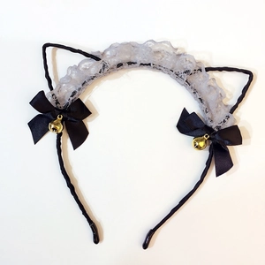 Detail of lace cat ear headband with black satin bows and gold ringing bells
