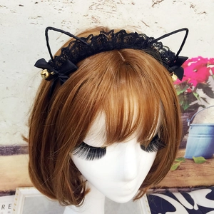 Close-up of black lace cat ears headband with black bows and golden bells on a model