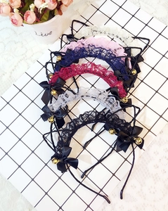 Flat lay of lace cat ear headbands with ribbons and bells in multiple colors