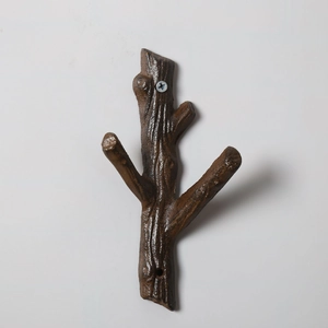 Detailed close-up of rustic branch cast iron wall hook with realistic wood texture