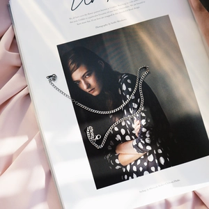 Artistic detail of 925 sterling silver chain necklace on a fashion magazine background