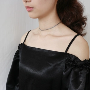Close-up of minimalist 925 sterling silver curb chain choker on a model's neck