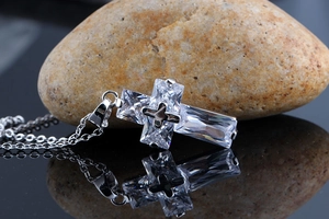 Macro view of silver cross necklace pendant inlaid with AAA rectangular cubic zirconia