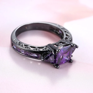 Gothic black gold ring featuring square purple zircon stone and hollow carving