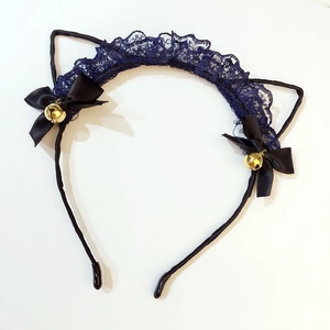 Detailed close-up of blue lace cat ears headband with black bows and golden bells