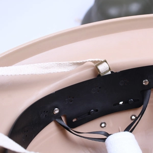 Khaki plastic helmet internal suspension system with black liner and adjustable straps