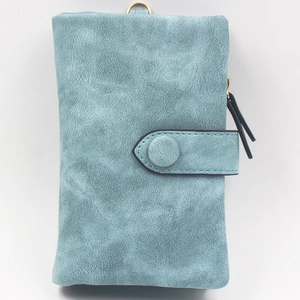 Detail of blue matte wallet featuring metal ring and secure snap button closure