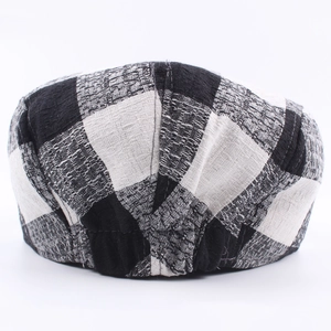 Classic black and white checkered ivy cap featuring textured weave and elastic back