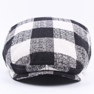 Classic black and white checkered flat cap for men and women with textured fabric design
