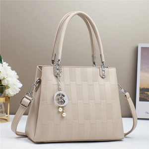Elegant beige embossed brick pattern handbag with silver hardware and pearl star pendant