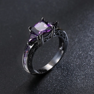 Gothic black gold ring featuring square purple zircon and intricate filigree details