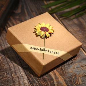 Close-up of kraft paper gift box with sunflower decal and Especially For You seal