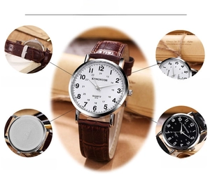 Detail view of quartz watch with stainless steel case and brown leather crocodile strap
