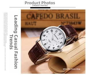 Detailed close-up of white quartz watch dial with brown crocodile leather strap