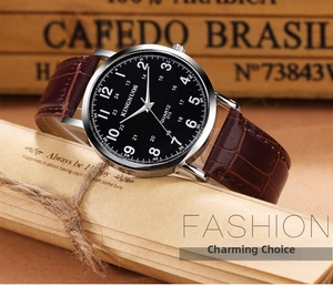 Classic quartz watch with brown leather strap and black dial on a vintage wood background