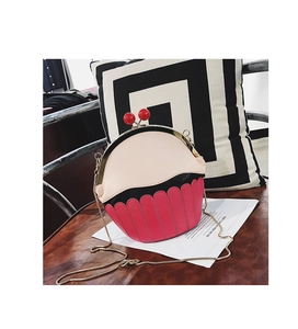 Detail showing creative pink cupcake-shaped PU leather chain bag on a leather seat
