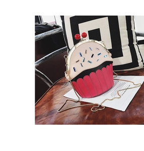 Detail view of a cupcake-shaped crossbody bag with pink PU leather and sparkling crystals