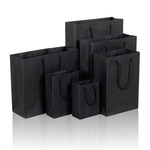 Set of six premium black paper gift bags in various sizes with rope handles on white background