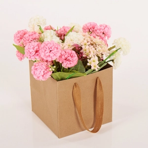 Brown kraft paper flower gift bag with sturdy woven handles and floral arrangement