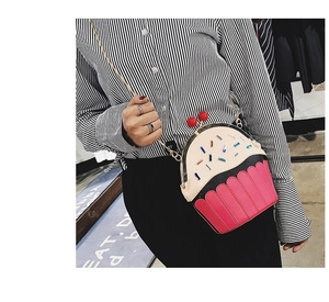 Detail of creative cupcake shoulder bag with colorful sprinkles and chain strap worn by a model
