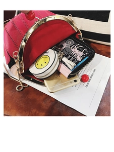 Interior view showing the capacity of a shell-shaped PU leather bag with gold chain strap
