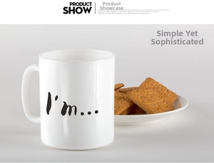 Detail of a white ceramic mug featuring minimalist black text and elegant curved handle
