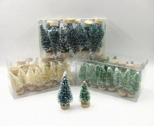 Detail view of mini frosted Christmas trees in blue-green and white with wooden bases