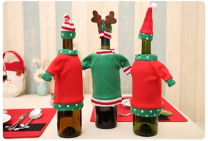 Detailed view of Christmas wine bottle covers with reindeer antlers and festive embroidery