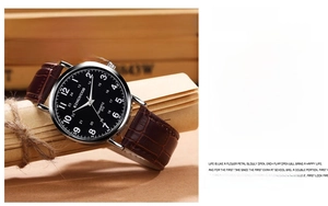 Detail of quartz watch with black dial and brown crocodile texture leather strap