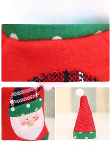 Detail of Christmas wine bottle cover featuring Santa applique and red felt fabric texture