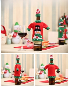Detail of Christmas snowman wine bottle cover with mini sweater and matching hat decor