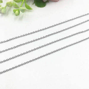 Detail shot of four slim silver stainless steel cable chains on white background