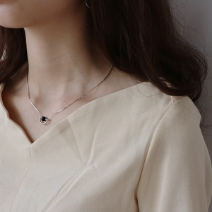 Detail of 925 silver necklace with black onyx pendant on neck for modern minimalist style