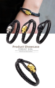 Detail of men's leather braided bracelets with skull charms in gold, silver, and black