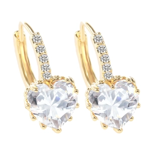 Close-up of golden heart earrings with sparkling clear zircon and micro-pave crystals