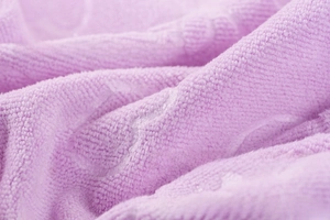 Detail of purple microfiber bath towel featuring embossed pattern and soft texture