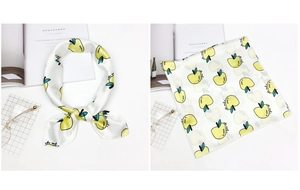Detail of satin square scarf featuring yellow apple prints with glasses and books
