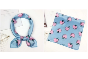 Detail of light blue silk scarf with pink apple prints shown tied and laid flat