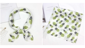 Close-up of square satin scarf featuring vibrant pineapple prints and polished edges