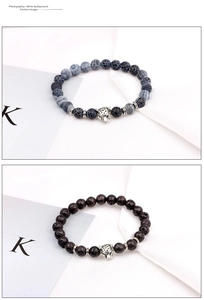 Macro detail of beaded bracelets with silver leopard heads and tiger eye stones