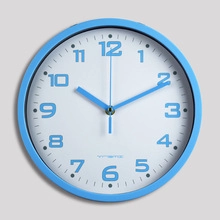 Detail of a sky blue aluminum silent wall clock with Arabic numerals and quartz movement