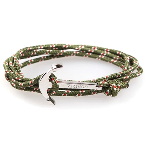 Detailed macro view of the silver Vikings anchor clasp on a green braided nautical bracelet