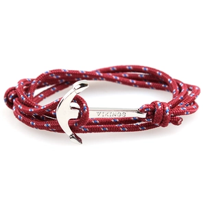 Detailed shot of red braided nautical rope bracelet with silver Vikings anchor buckle