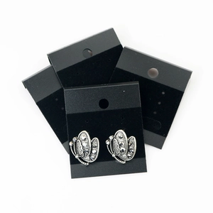 Retro silver butterfly stud earrings with grey rhinestones on a black display card