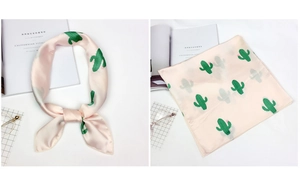 Detail view of pink satin square scarf with green cactus pattern and smooth texture