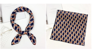 Detail of satin square scarf with geometric patterns in navy, orange and white silk finish