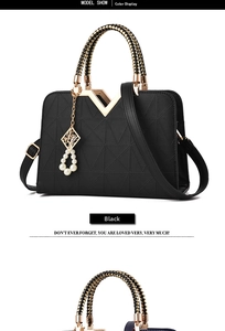 Detail of black faux leather handbag with geometric patterns and golden V hardware